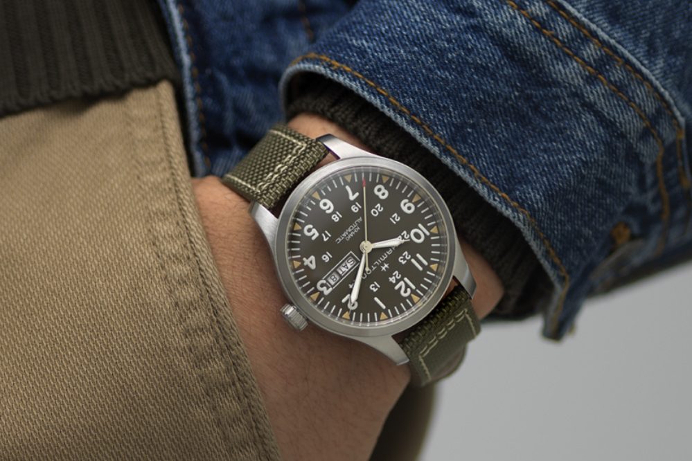 Close-up of a man wearing a field watch