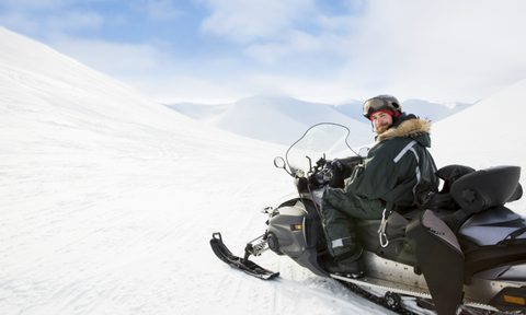 best snowsuits for men man in snow suit on machine getty images