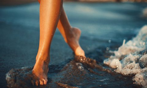 woman feet sand beach ocean