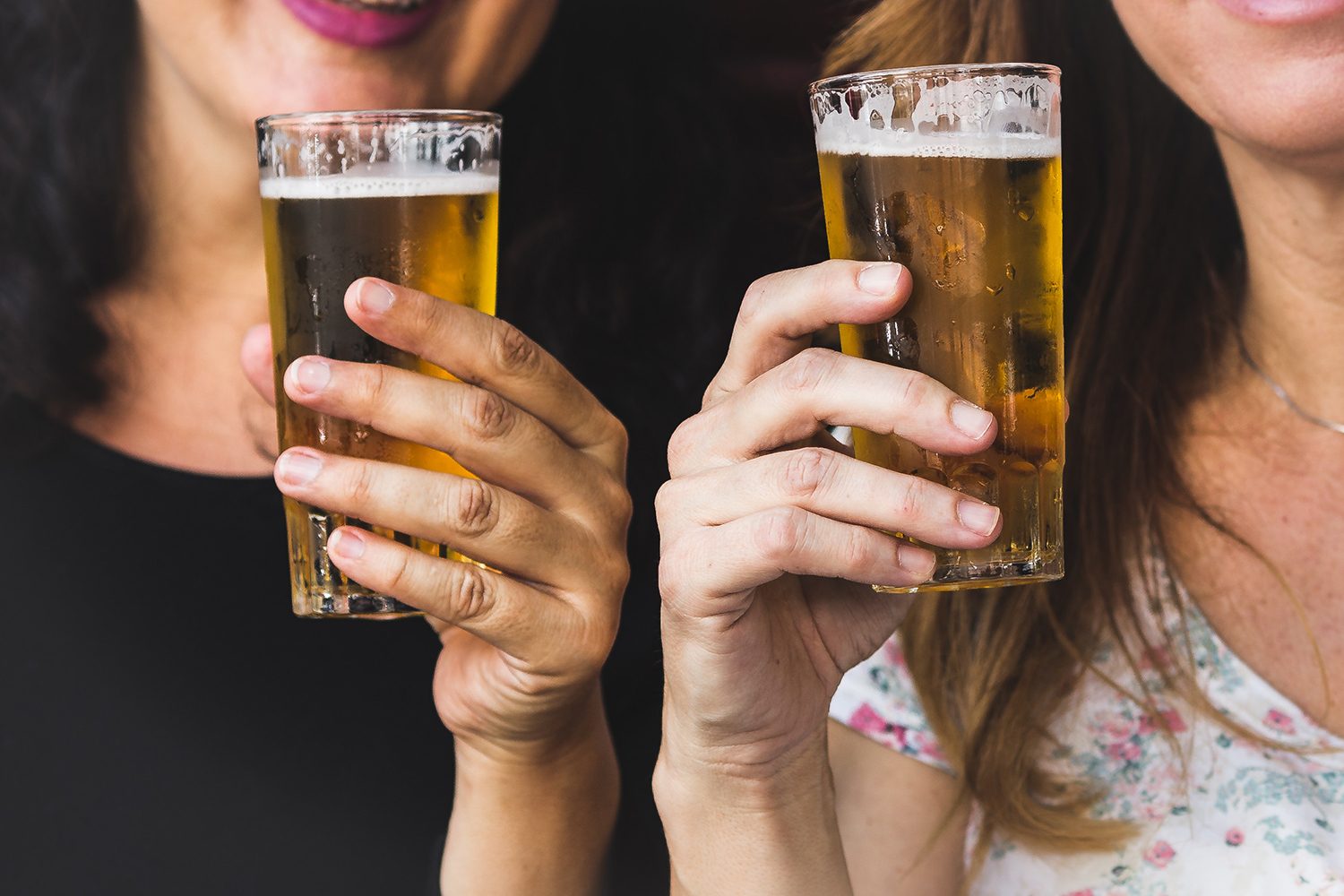 Holding Pilsner beer glasses