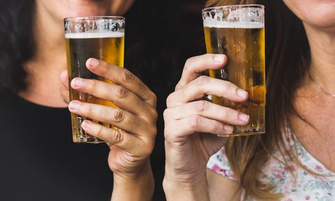 Holding Pilsner beer glasses