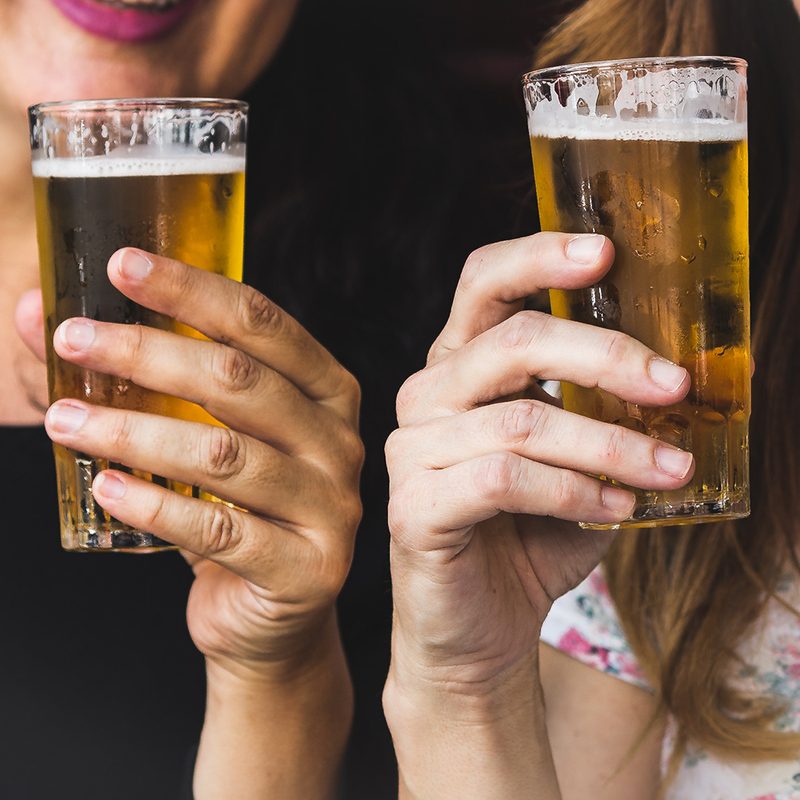 Holding Pilsner beer glasses