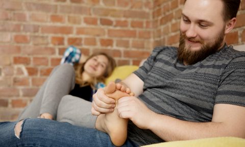 how to give a romantic massage man massaging wifes feet getty images