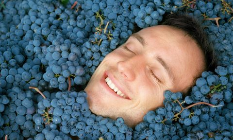 resveratrol grooming products wine skincare  man swimming in grapes