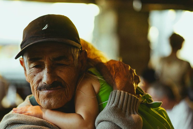 retired-man-carrying-granddaughter-recrop