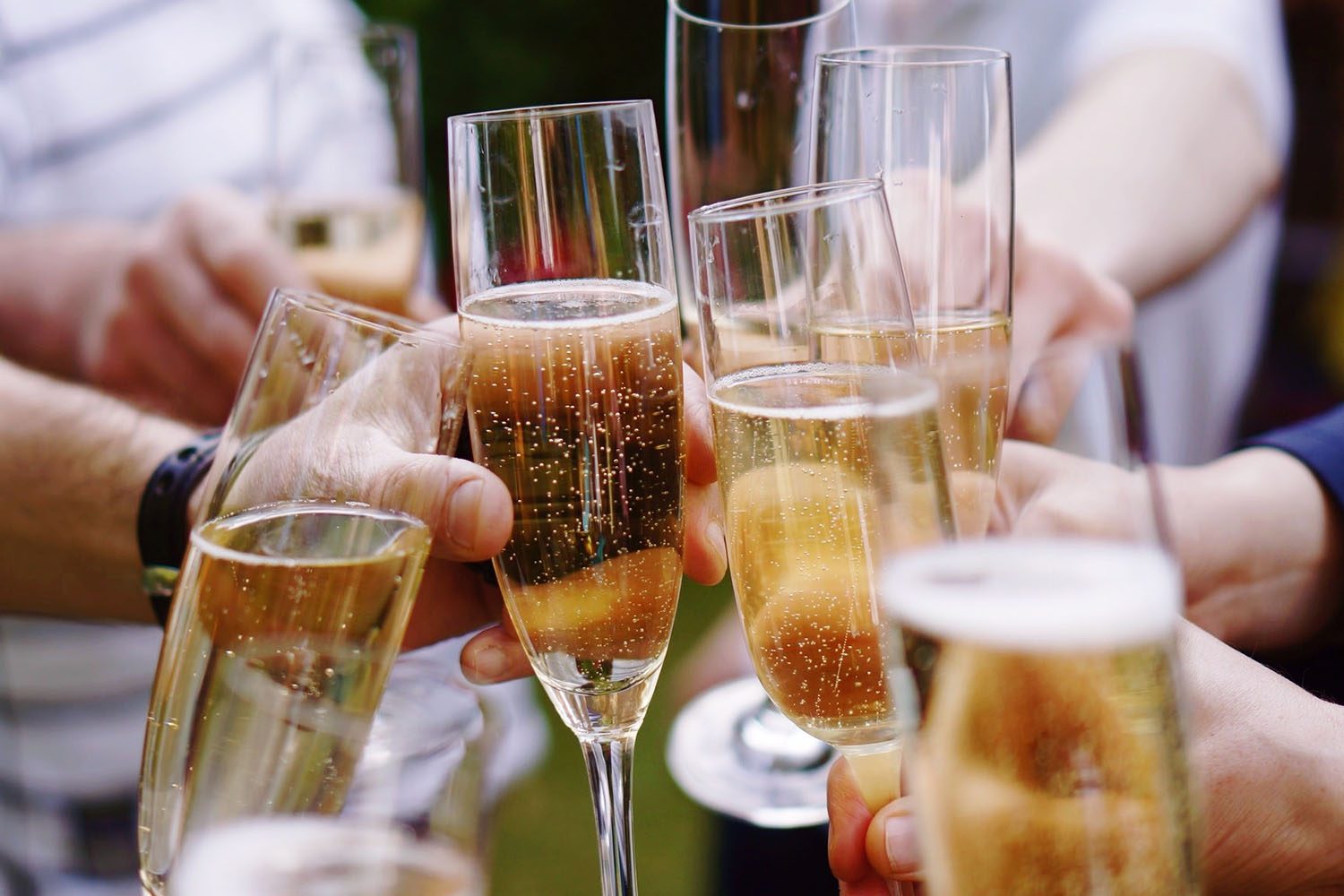 A toast with several glasses of sparkling wine.