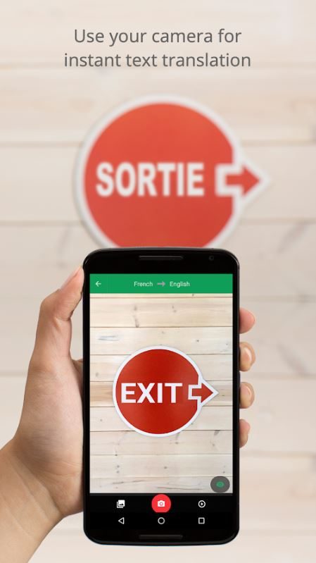 A hand holding a phone that shows the English translation of "Exit."