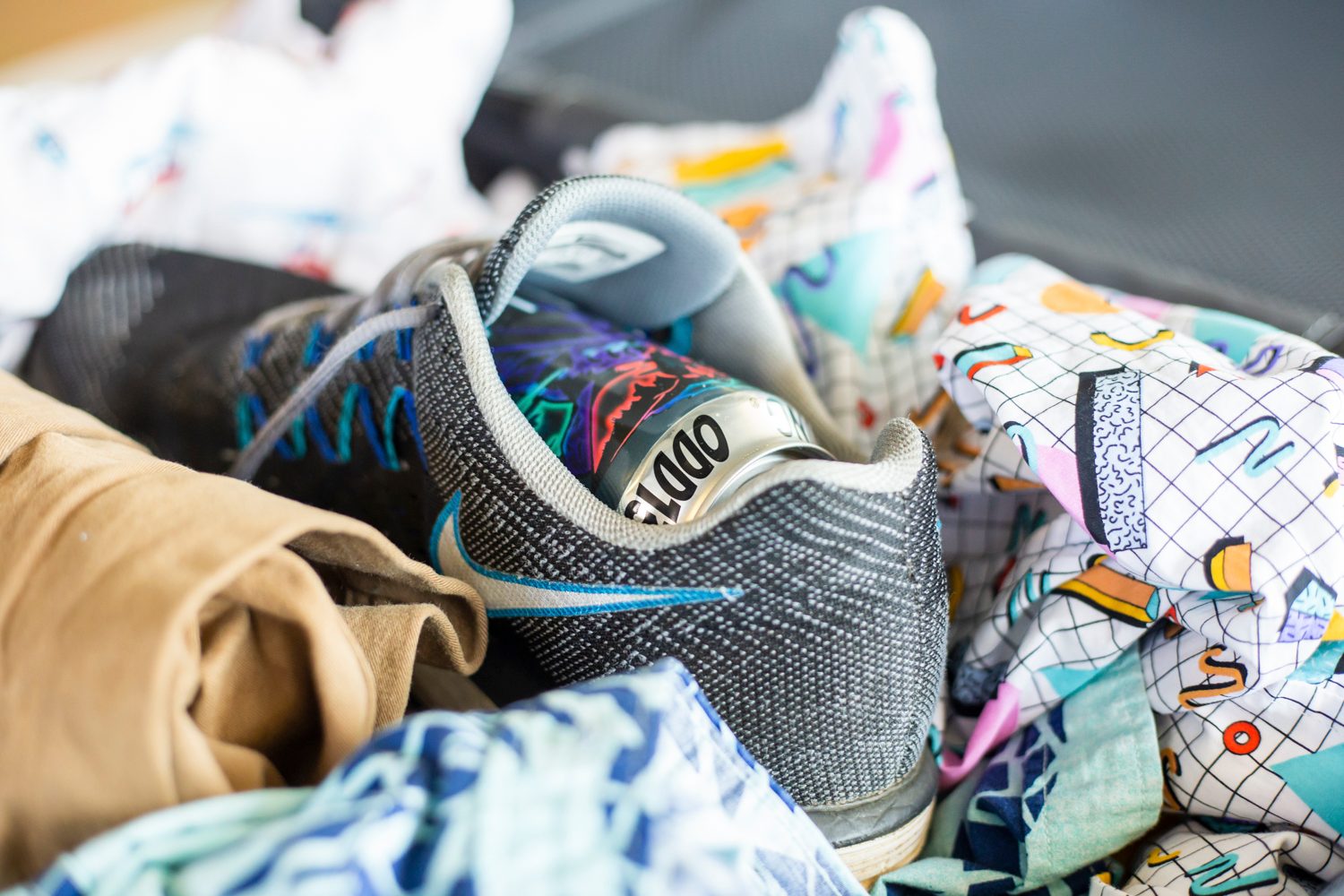 Close-up of packing a can in a suitcase