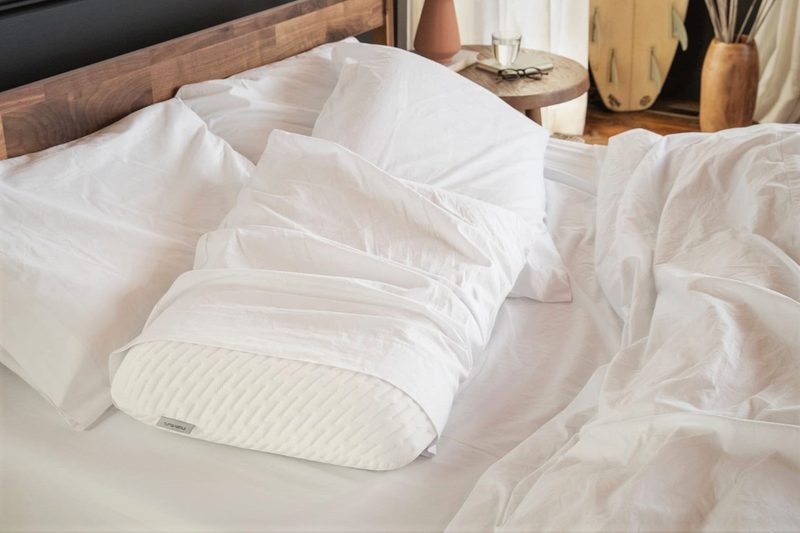 Tuft and Needle Pillow on a bed.