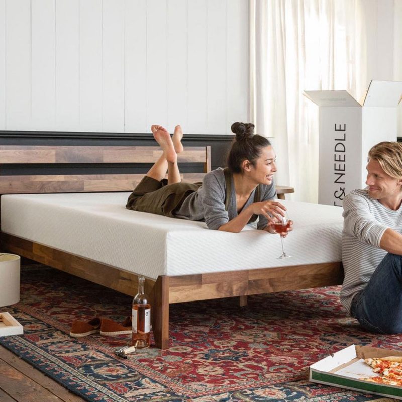 A couple eating after unboxing the Tuft & Needle memory foam mattress.