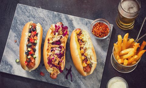 Three hot dogs with different topppings
