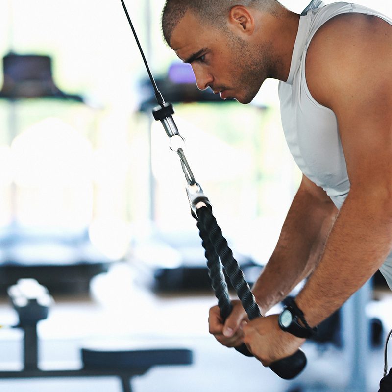 Man doing tricep pressdowns.