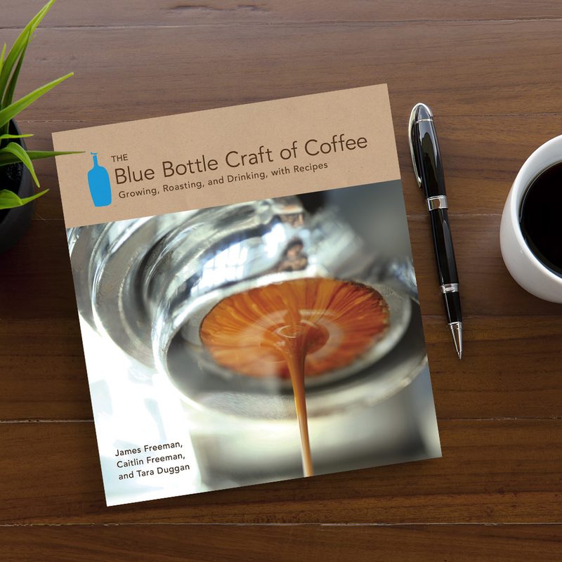 The Blue Bottle Craft of Coffee by James Freeman on a wooden table.