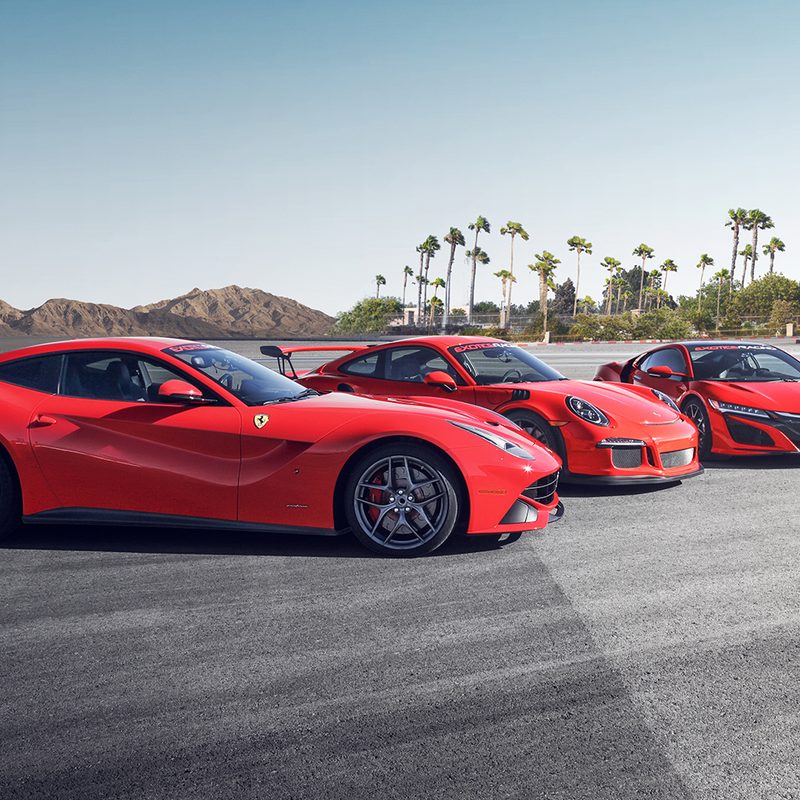 Three exotic supercars lined up in a parking lot in Las Vegas, Nevada.