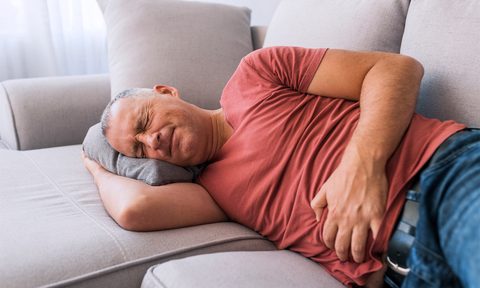 Man in pain on the couch