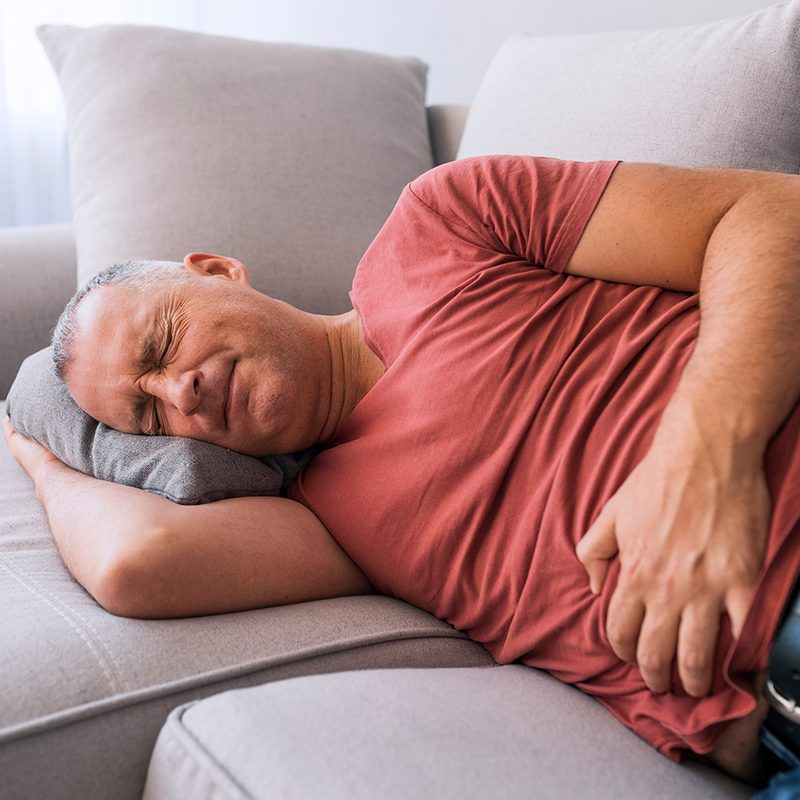 Man in pain on the couch