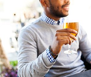 Man drinking a beer at a cafe