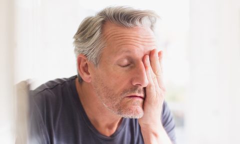 what are hemorrhoids treatment man in pain bathroom getty images
