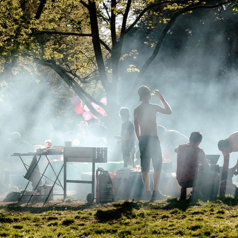 People around a smoke from a grill outside