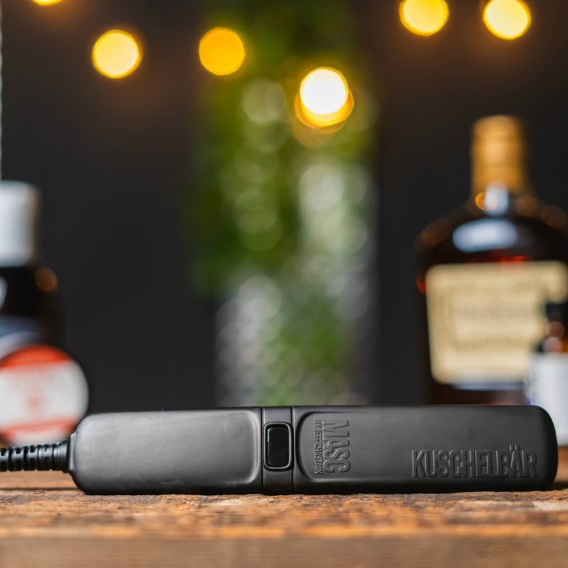 A beard straightener placed on a wooden table