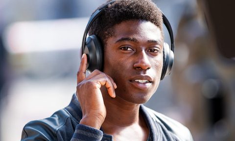 A man wearing the Bose 700 noise-cancelling headphones