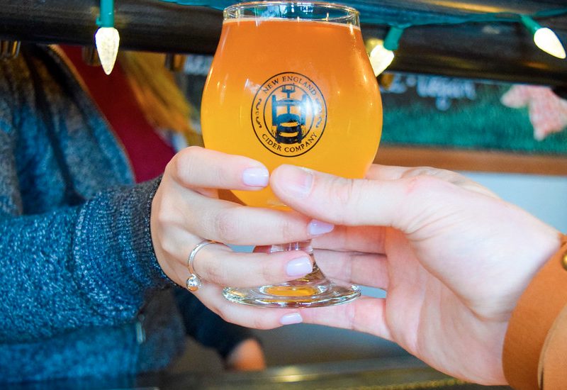 A glass of New England Cider Co. Barrel Aged Cider.