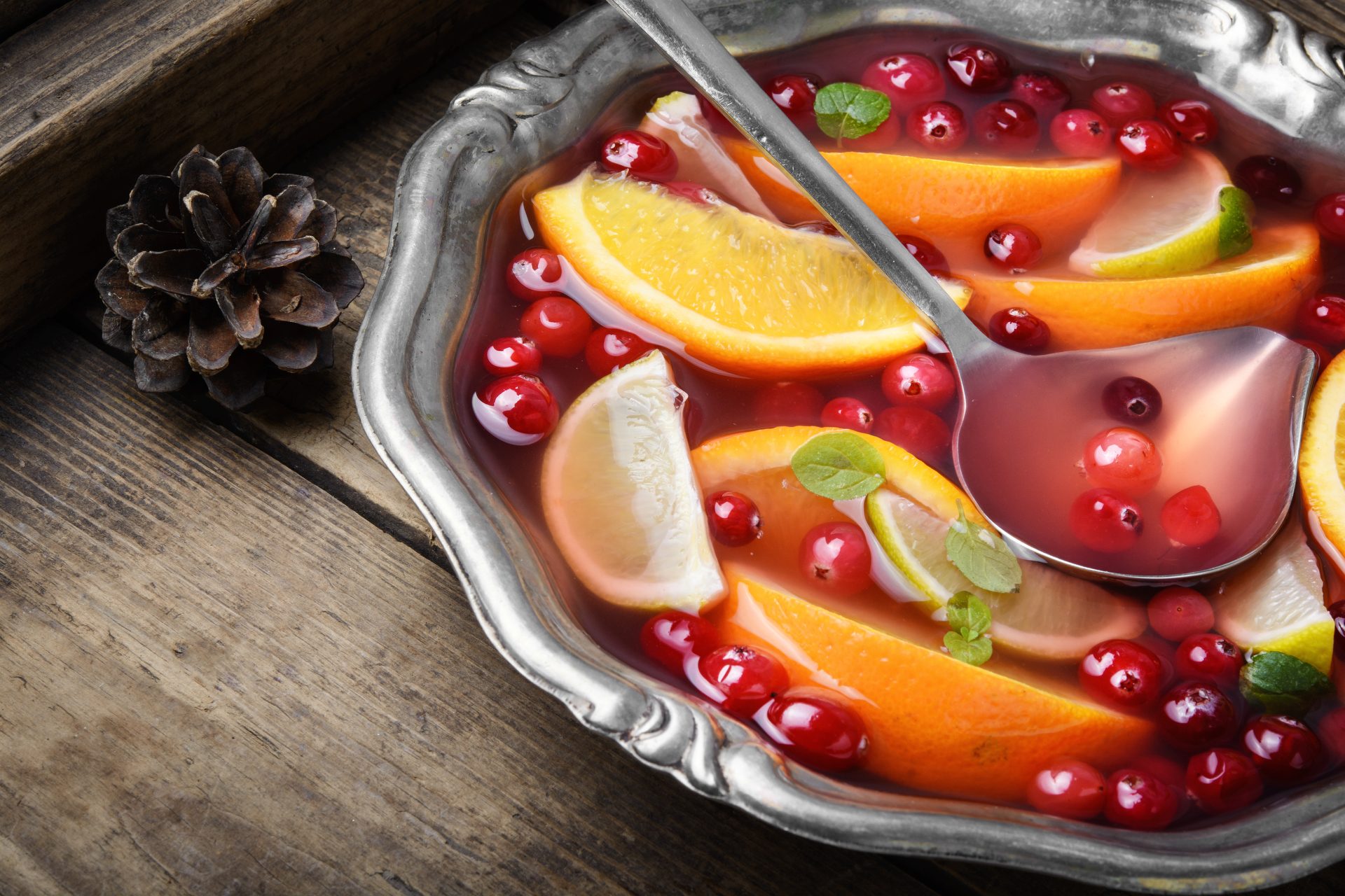 Alcoholic cocktail with pieces of fruit and berries in a bowl