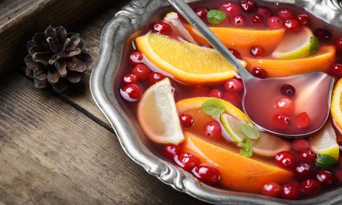 Alcoholic cocktail with pieces of fruit and berries in a bowl
