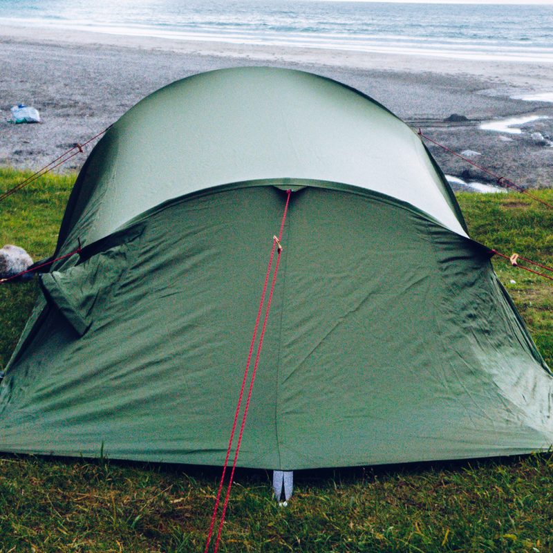 A green tent on grass.