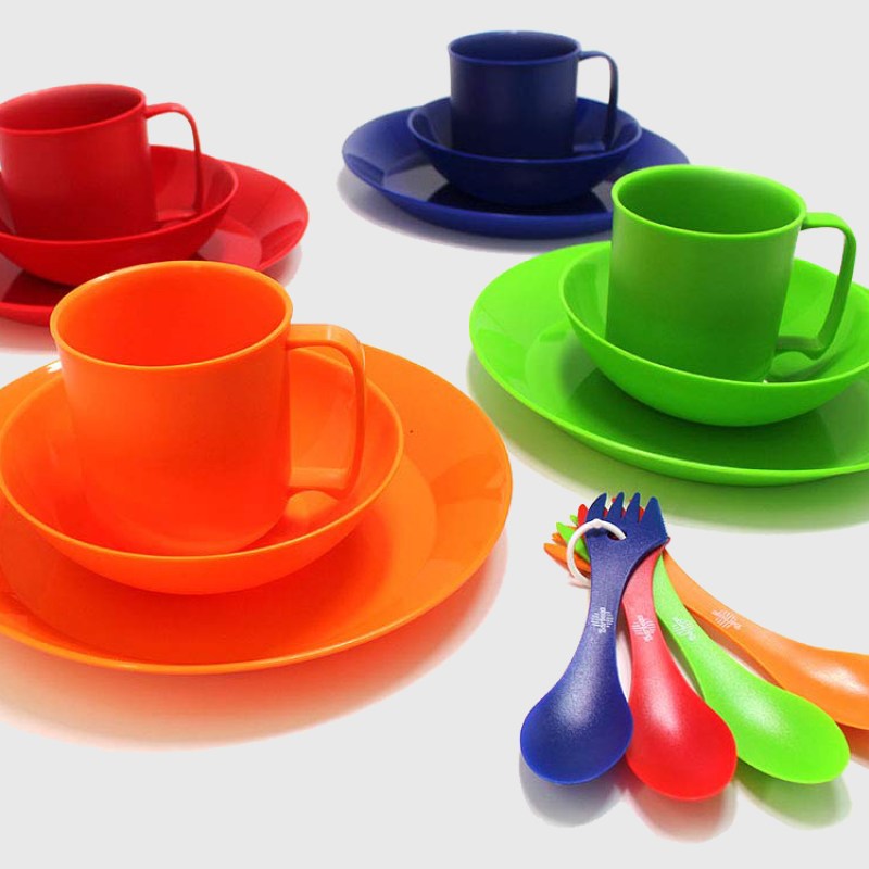 Colorful dinnerware set on a gray-ish white backdrop.