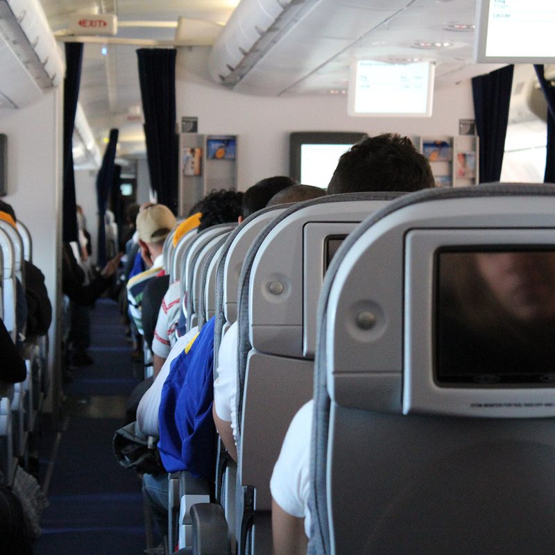 The inside of the cabin of an airplane full of passengers