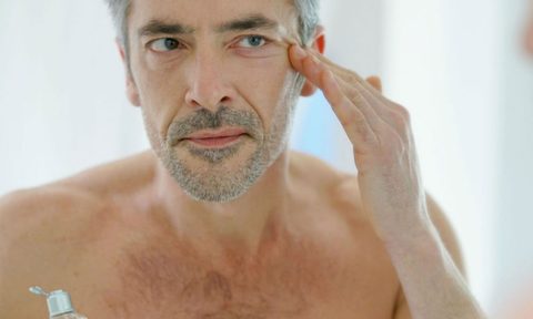 Man checking his skin in the mirror