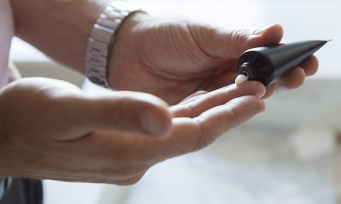 Person applying CBD cream to their hands.
