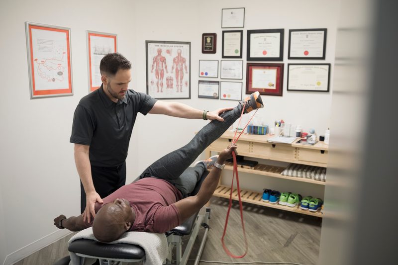 A chiropractor working on a patient