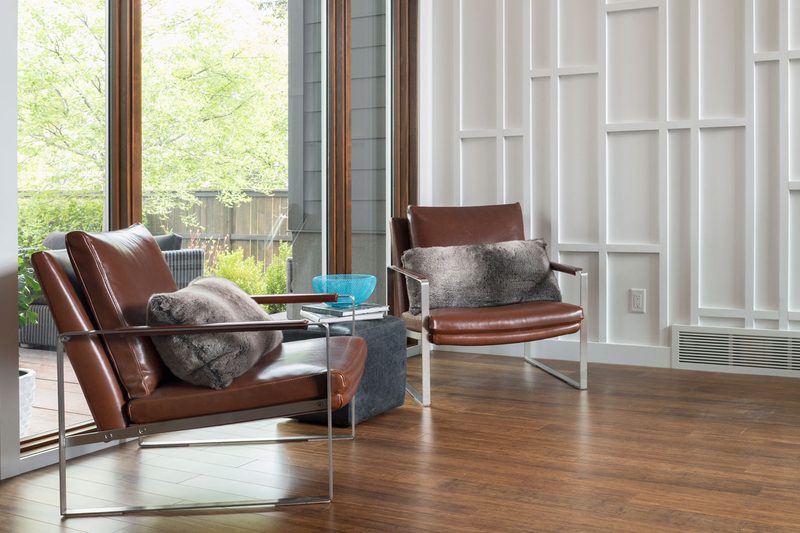Lounge chairs with pillows in a room.
