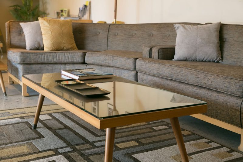 A table and sofa in living room.