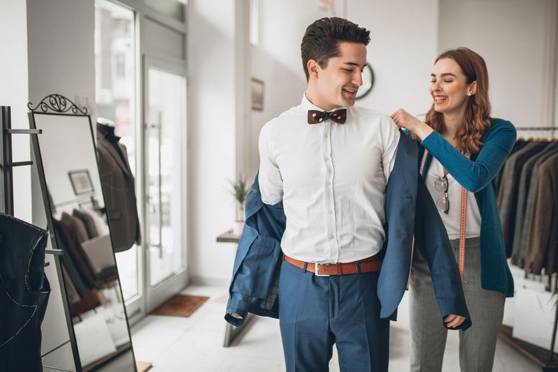 man getting suit fitted