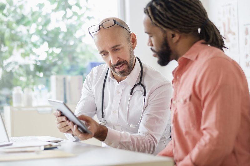 man talking to doctor diagnosis