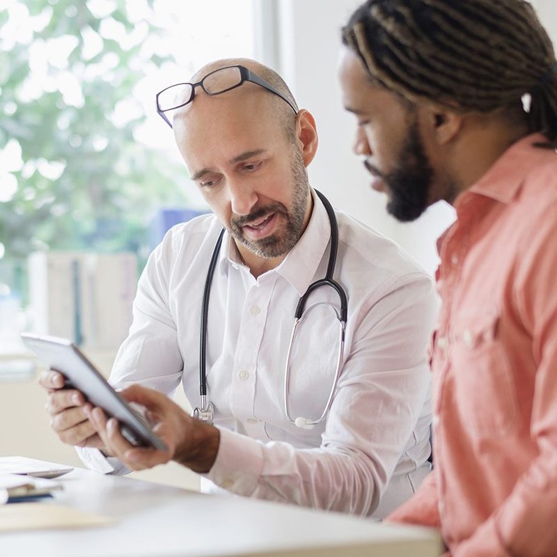 man talking to doctor diagnosis