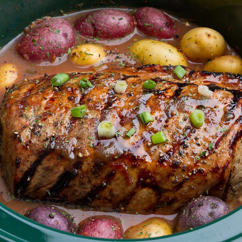 slow cooker pot roast with potatoes in a pot.