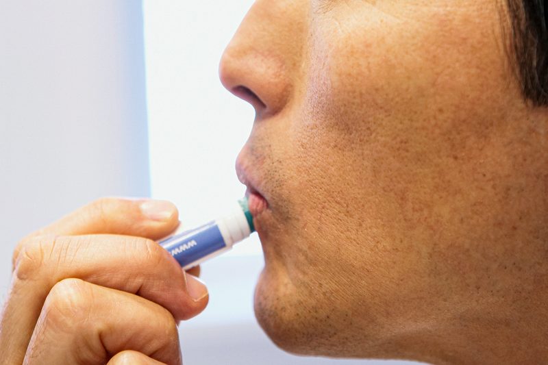 Man applying chapstick