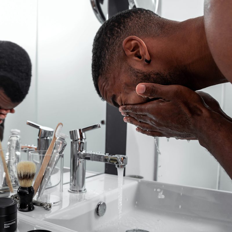 Man washing his face
