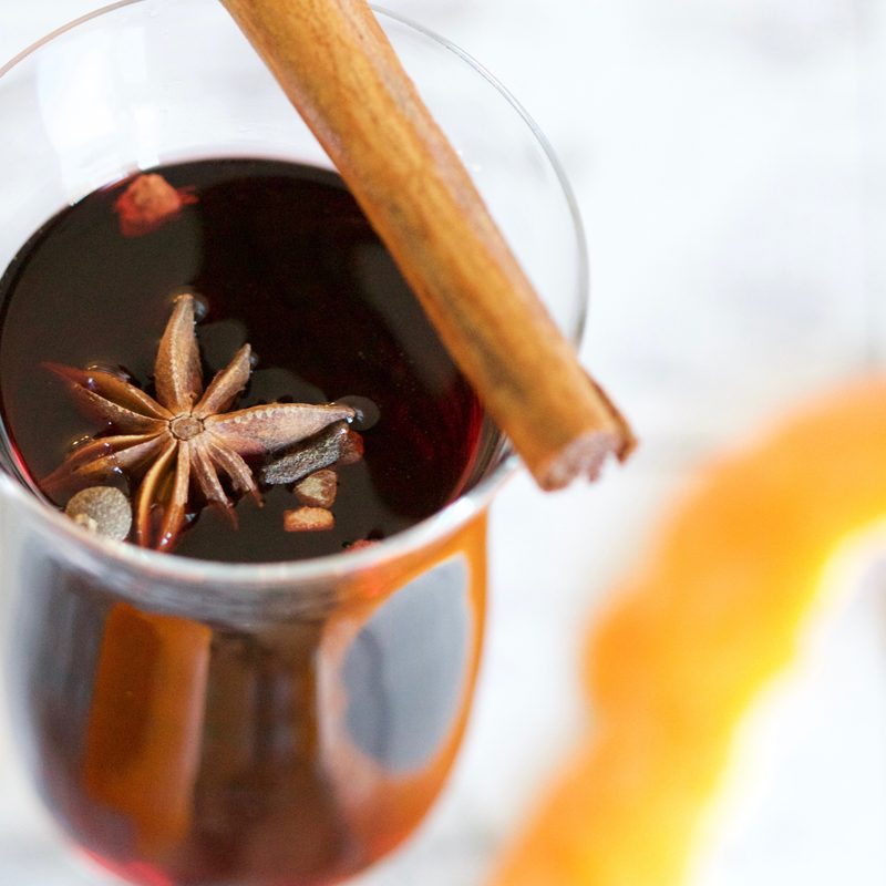 Glass of mulled wine with a cinnamon stick on top