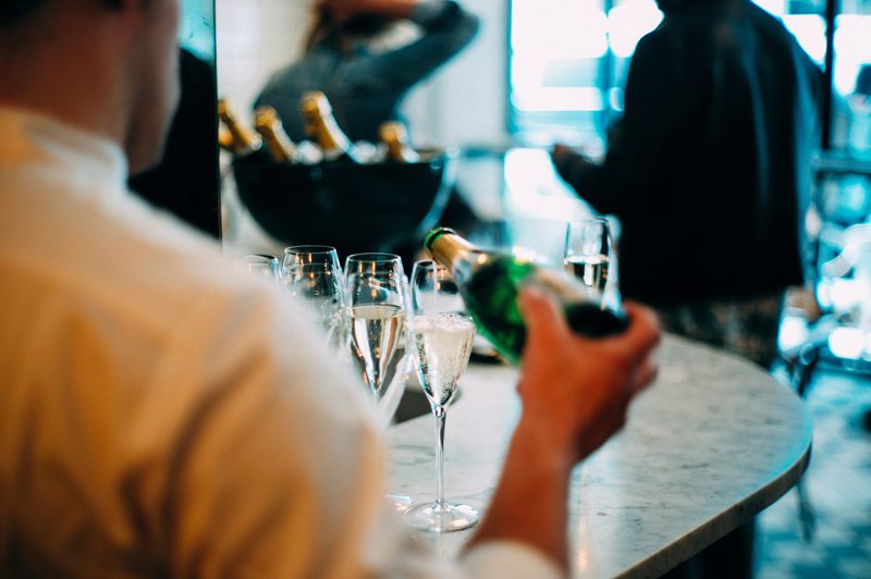 man pouring sparkling wine