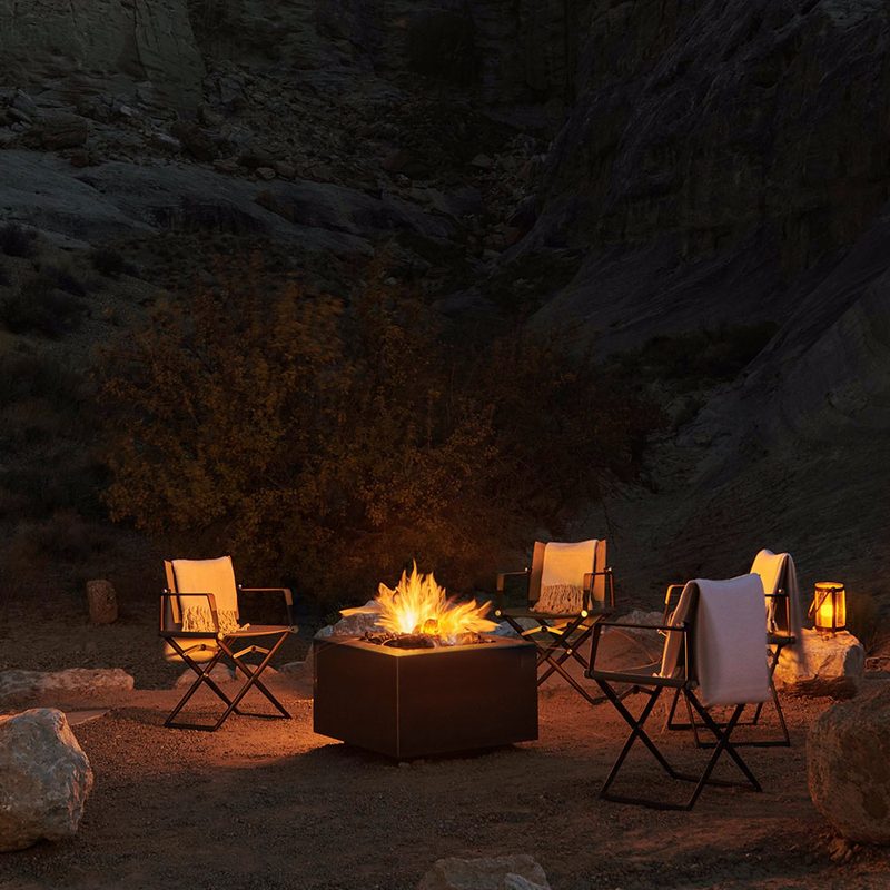 A fireplace and four chairs at Amangiri Mesa Pool Suite in Utah.
