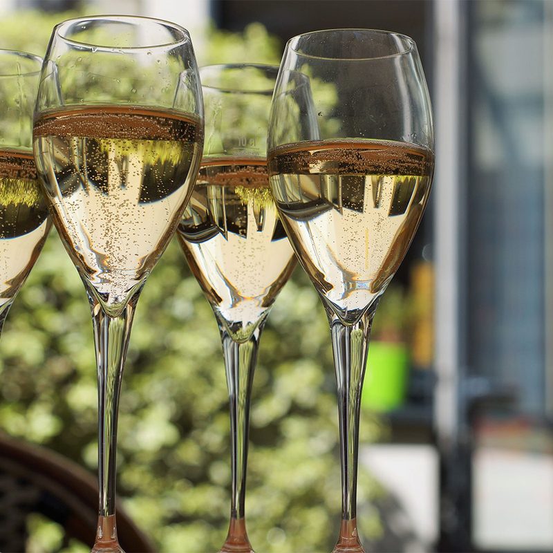 Four glasses of wine on the foreground.