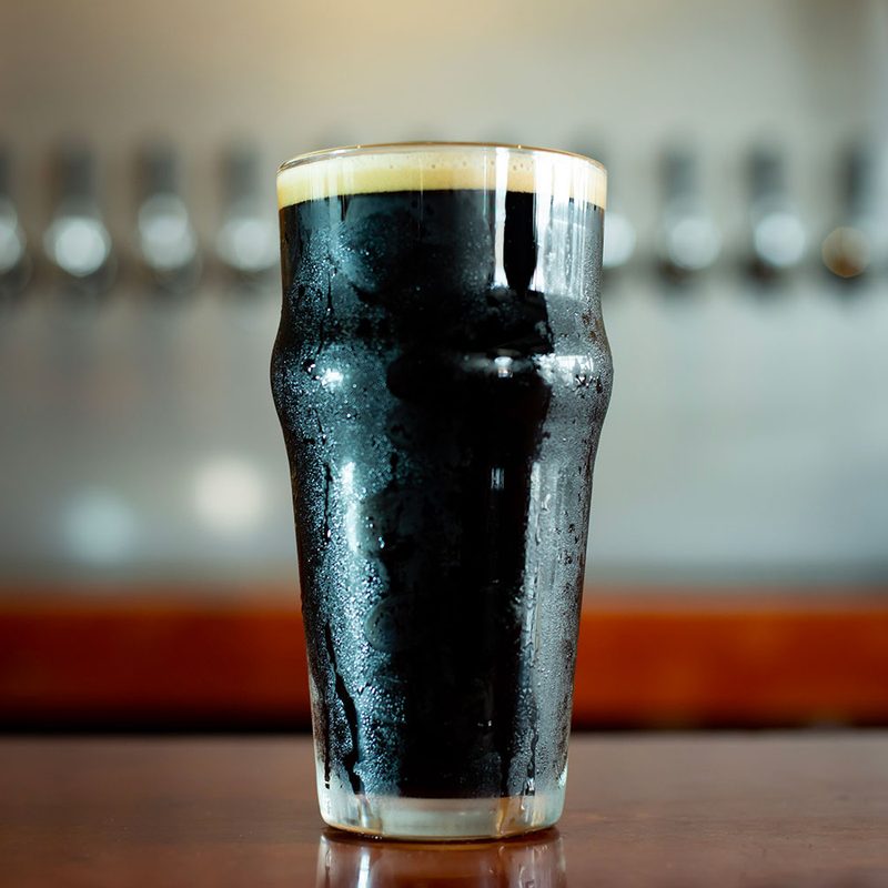 A pint of stout at the bar.