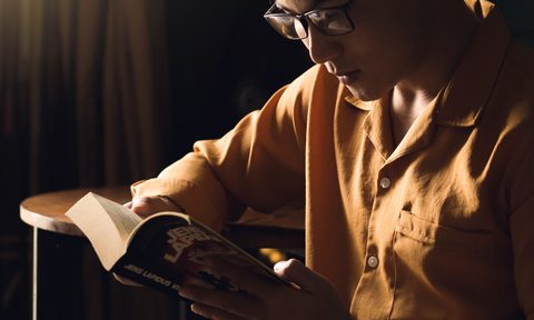 man with glasses reading