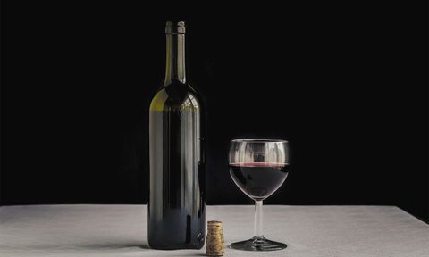 Standard wine bottle with a glass of red wine