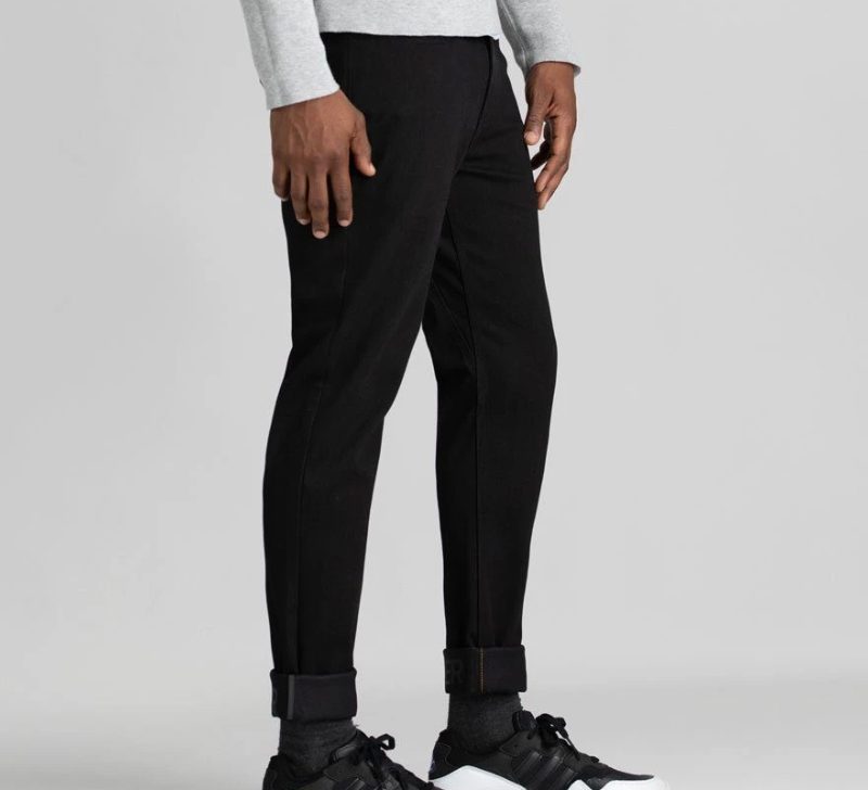 A mean wearing Duer all weather denim jeans in black.